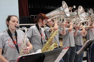 band students play saxophones and tubas