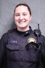 a woman in a police officer's uniform smiles