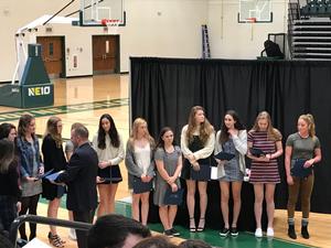 teenage girls stand together holding awards