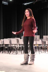 a girl on a stage speaking