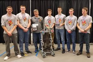 members of robotics team with their plaque