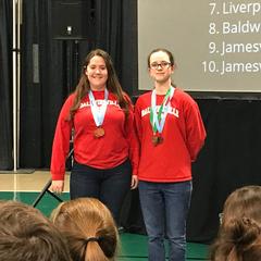Two teenage girls with medals around their necks