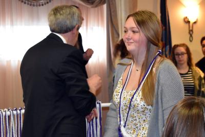 a young woman receives an award