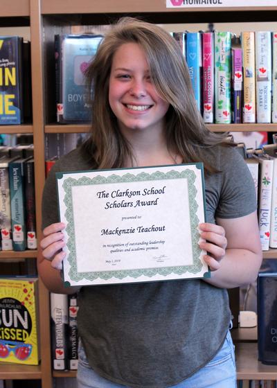 a girl holds a certificate