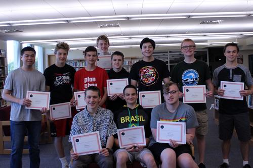 a group of boys hold certificates