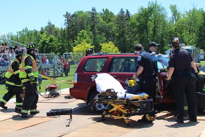 emergency responders work to get victim out of car
