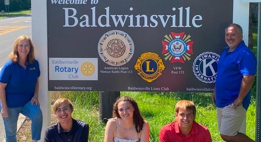 Giving back to the community: Baker students help update 'Welcome' sign